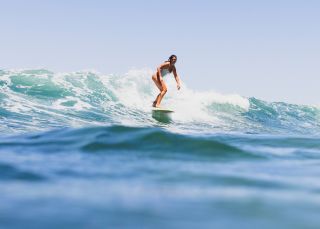 Surfer riding a wave, Bilgola Beach