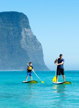 Family stand-up paddleboarding, Lord Howe Island
