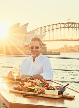 Man enjoying grazing plate on Ghost 2 Super yacht, Sydney Harbour