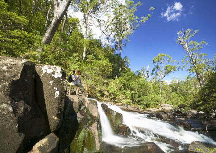 Couple admiring Gloucester Falls at Gloucester Tops, Barrington Tops National Park, NSW, Australia