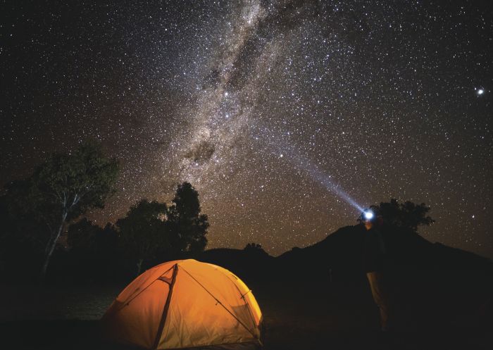 Camper gazing up at the galaxy of stars, Warrumbungles