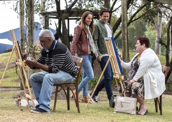 Local Aboriginal artists Denise Hedges and Les Ahoy working on their artwork on the WUPA@Wanuruah Art Trail at Hunter Valley Resort