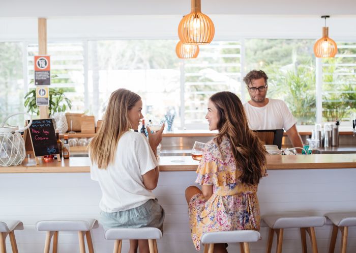 Women enjoying drinks at Avoca Surf House, Avoca Beach