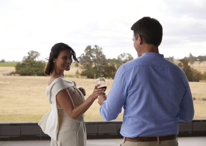 Couple enjoying a glass of wine at Shaw Wines in Murrumbateman, Yass Area