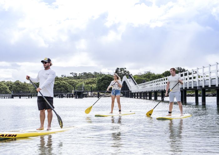 Friends enjoying a stand up paddleboarding experience with SWR SUP along Back Creek, South West Rocks, North Coast