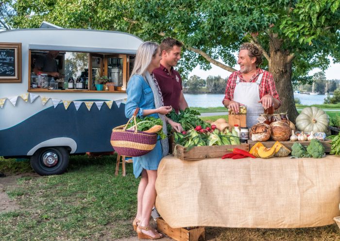 Couple shopping for fresh produce at the SAGE Farmers Market in Moruya, Batemans Bay