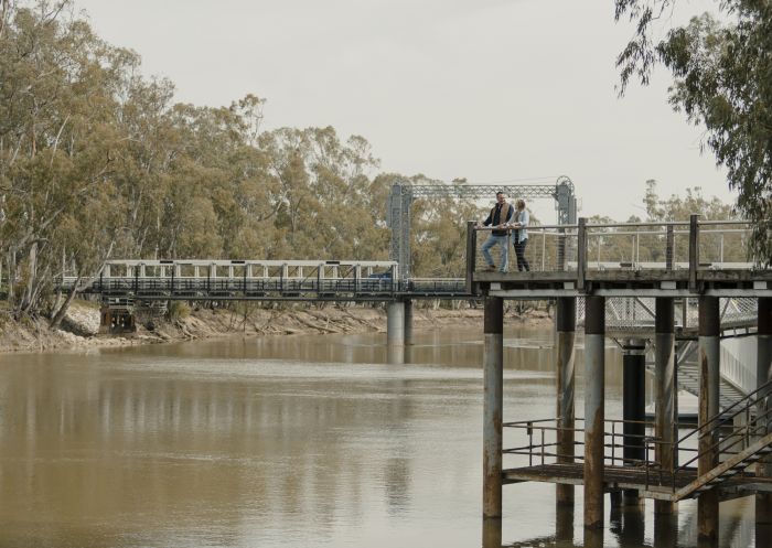 Couple enjoying the scenic views across the Murray River along the Koondrook Barham Redgum Statue River Walk, Barham, The Murray