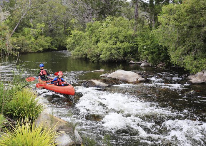 Father and son enjoying a canoeing experience along the Barrington River with Barrington Outdoor Adventure Centre.