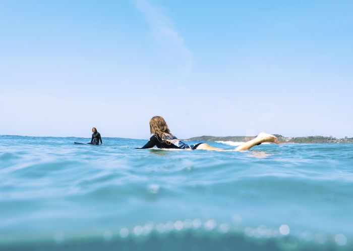 Couple enjoying a surf at Catherine Hill Bay, Lake Macquarie, North Coast