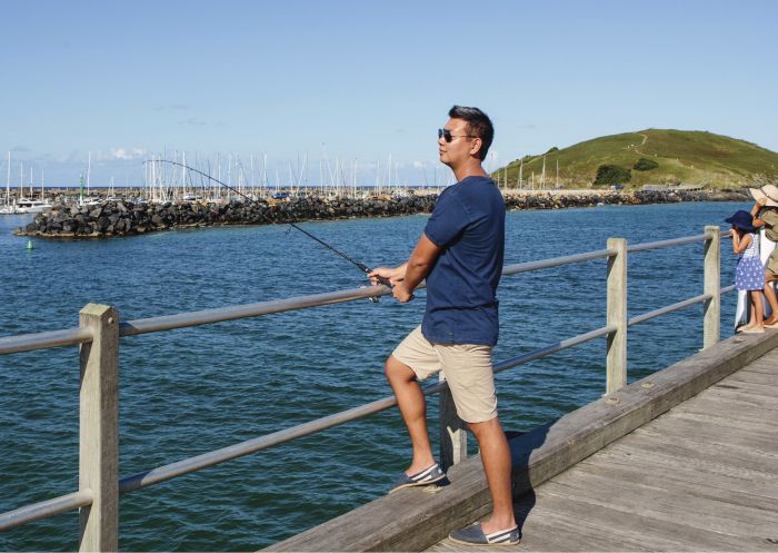 Man fishing off the jetty in Coffs Harbour