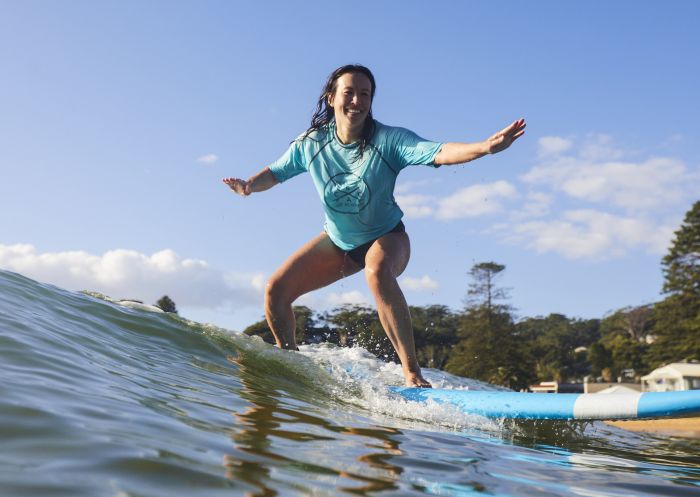 Student enjoying a learn to surf experience with Central Coast Surf Academy, Avoca Beach