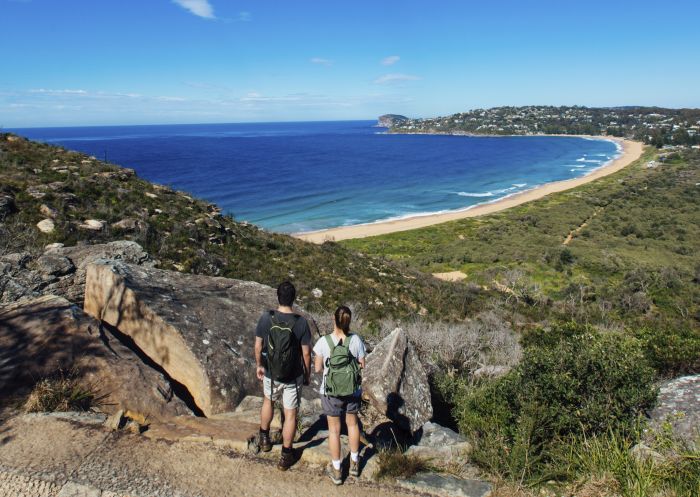 Couple enjoying a scenic coastal hike on the Barrenjoey Lighthouse Walk in Palm Beach, Sydney