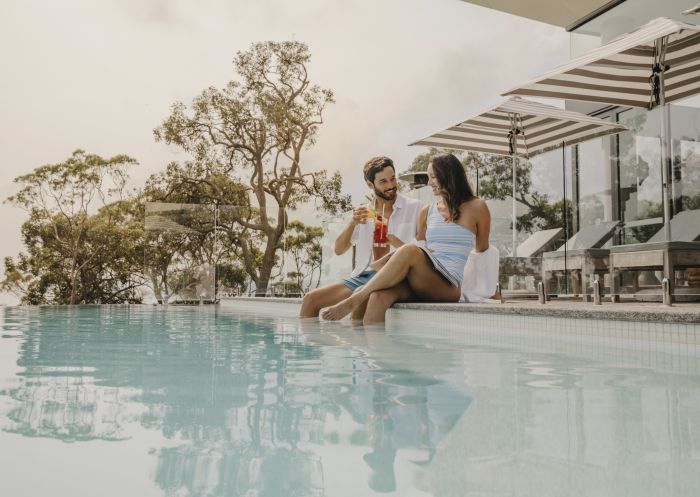 Couple relaxing by the pool at Bannisters, Port Stephens