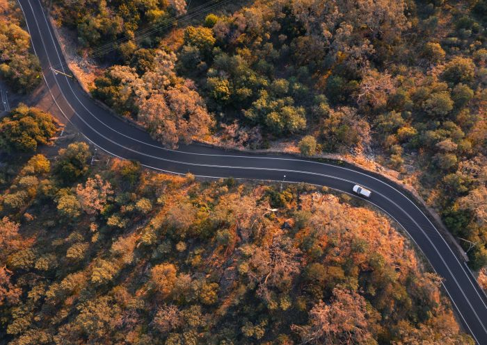 Aerial overlooking a car driving through the countryside near Tamworth