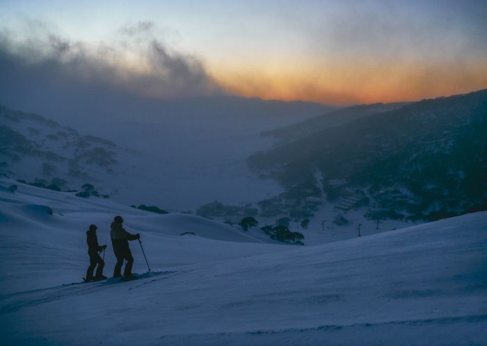 Couple enjoying a day of skiing at Charlotte Pass Ski Resort in the Snowy Mountains