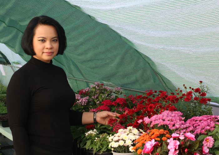 Bee Satongun choosing edible flowers at Zen Micro Farm