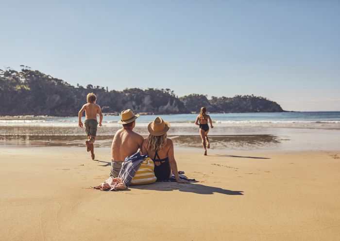 Family enjoying a visit to McKenzies Beach, Malua Bay