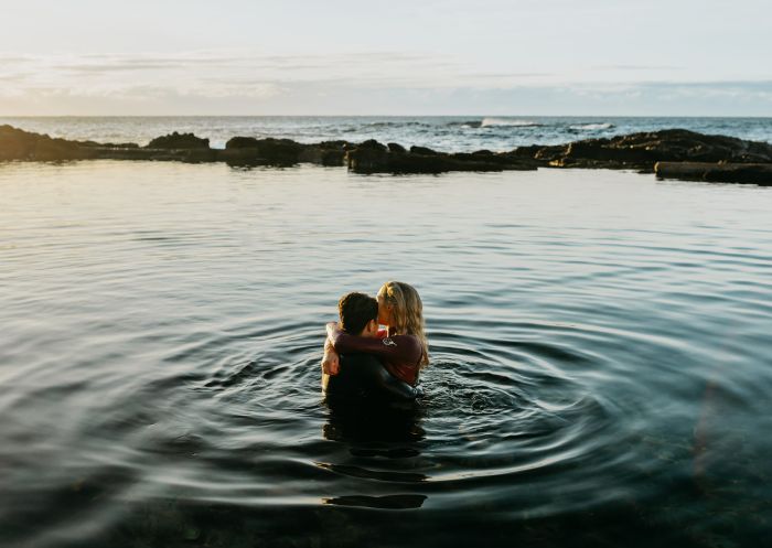 Couple enjoying the ocean pool at Bermagui Blue Pool, Bermagui