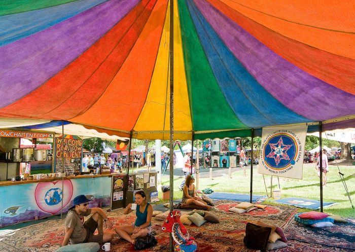 People drinking chai under The Rainbow Chai Tent at the The Channon Craft Market, Lismore