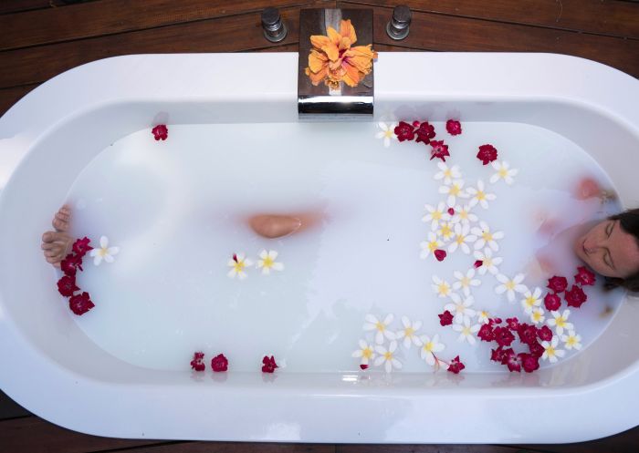 Woman enjoying bath at Arajilla Retreat, Lord Howe Island