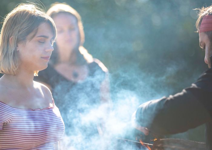 Woman experiencing smoking ceremony at Yuin Retreat by Ngaran Ngaran Culture Awareness, Sapphire Coast