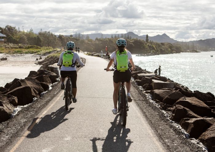 People enjoying a bike ride by the beach with Byron E-Bikes, Byron Bay