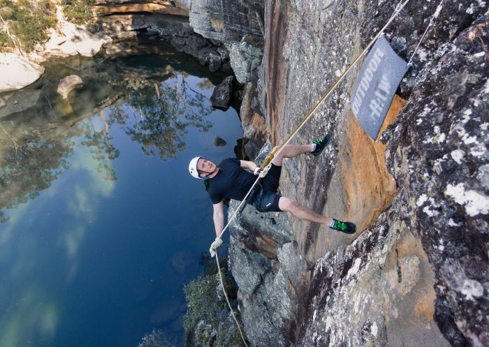 Man enjoying an abseiling experience with Outdoor Raw, Shoalhaven