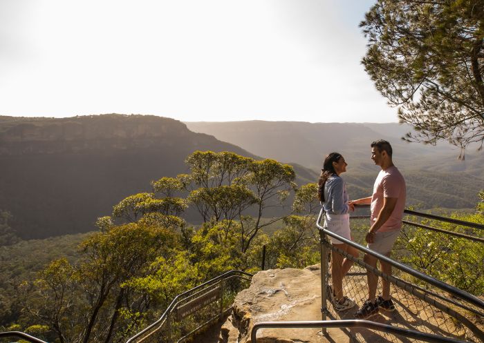 Couple enjoying views overlooking the Jamison Valley along the Three Sisters Walking Trail, Katoomba