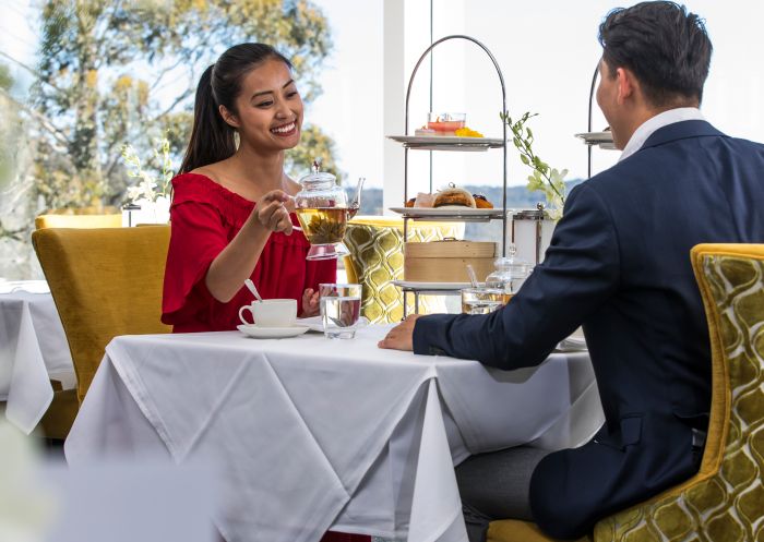 Couple enjoying a premium afternoon high tea - Wintergarden restaurant within The Hydro Majestic Hotel, Medlow Bath