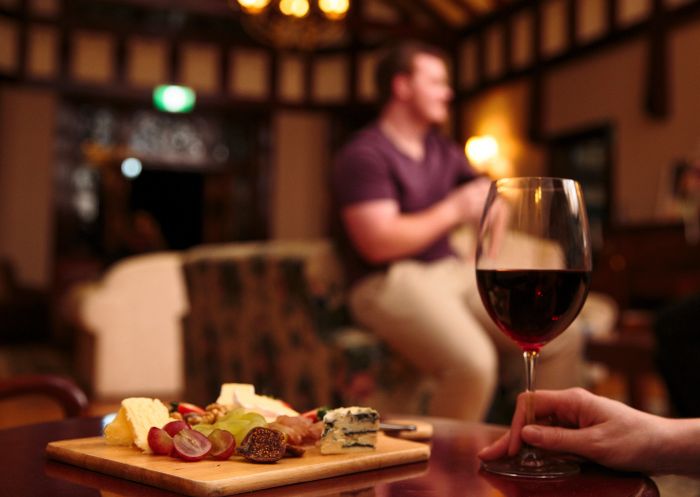 Red wine and a cheese platter awaiting guests at Petersons Armidale Winery and Guesthouse, Armidale 