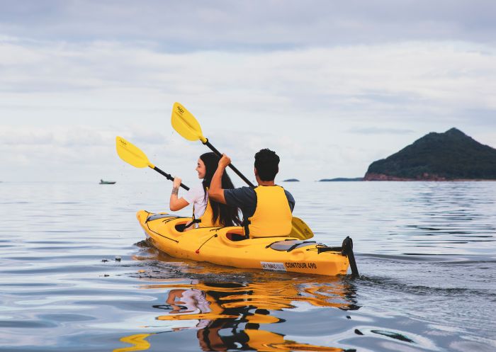 Couple enjoying a day of kayaking along the Karuah River off Jimmys Beach, Hawks Nest