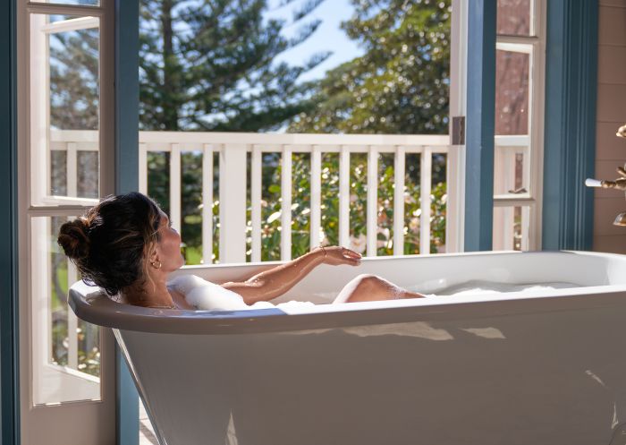 Woman enjoying bath in the sun at Greyleigh, Kiama