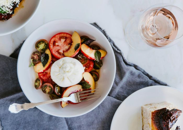 Table spread of food including burrata with local tomatoes, focaccia & eggplant parmagiana at the The Barn at Blue Wren Farm, Eurunderee