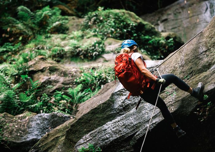 Woman abseiling Gap Creek Falls in Watagans National Park