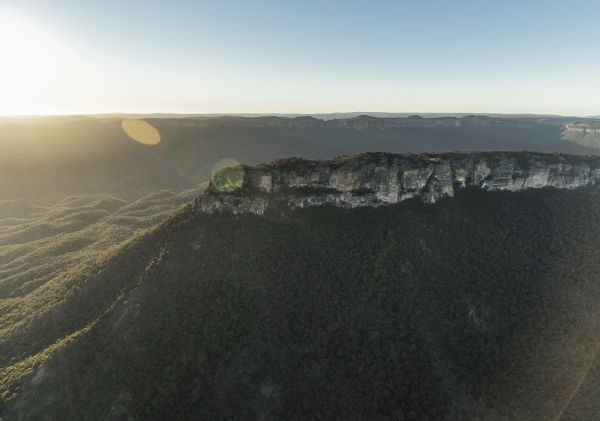 Sun rising over Pantoneys Crown tableland, Capertee Valley in the picturesque Gardens of Stone National Park.