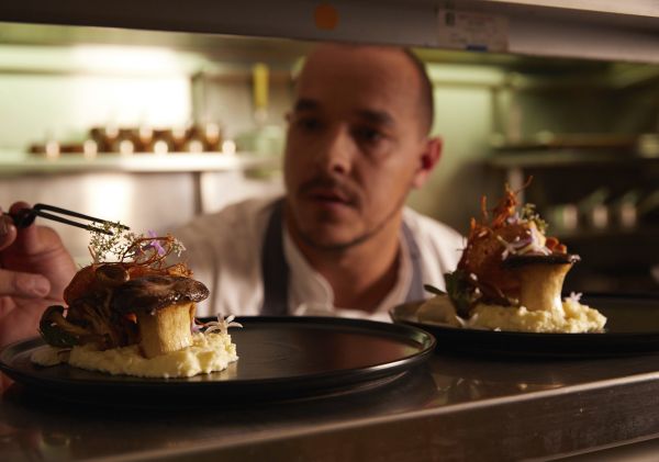 Chef Matthew Roberts placing the finishing touches to a dish at Eschalot, Berrima.