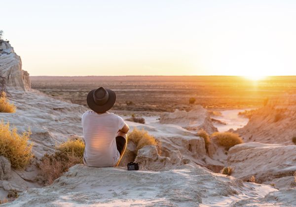 Man watching the sunset at the Walls of China in Mungo National Park, Mungo