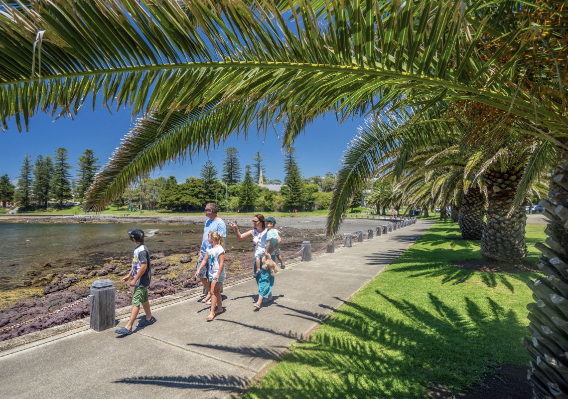 Family enjoying a walk around the harbour at Pheasant Point, Kiama.