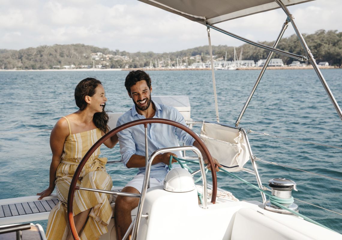 Couple on a boat sailing in Shoal Bay in Port Stephens