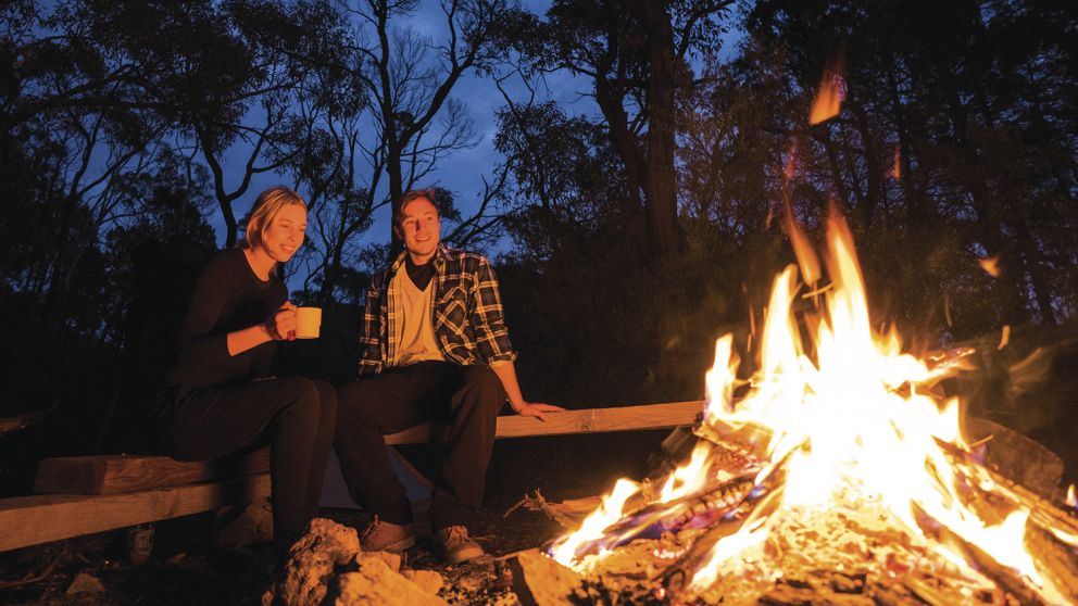 Couple by their campfire at Balor Hut Campground in Warrumbungle National Park