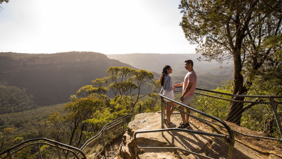 Couple enjoying views overlooking the Jamison Valley along the Giant Stairway Walking Track, Katoomba