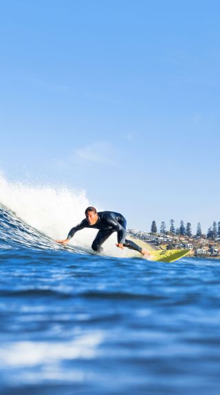 Man surfing at Werri Beach in Gerringong, Kiama Area, South Coast NSW