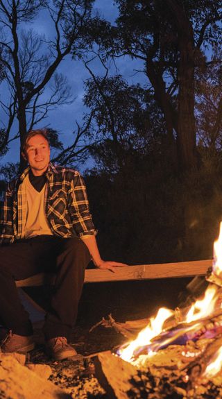 Couple by their campfire at Balor Hut Campground in Warrumbungle National Park