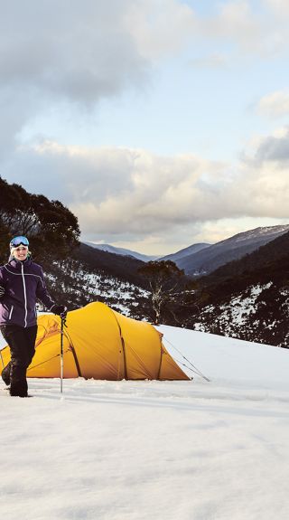 Couple snowshoeing by their campsite through Dead Horse Gap, Thredbo in the Snowy Mountains