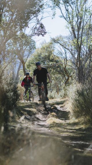 Couple enjoying a day of mountain biking on the Thredbo Valley Track in Kosciuszko National Park