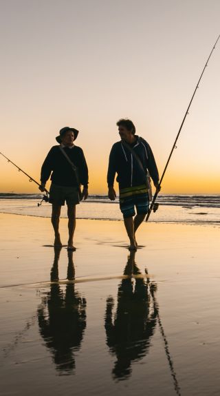 Fisherman walking along Iluka Beach in Iluka, Clarence Valley - Credit: My Clarence Valley