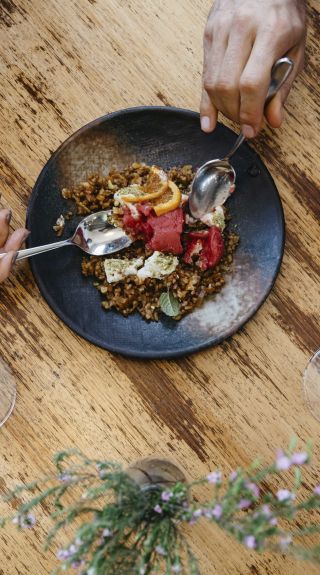 Couple enjoying food and drink at Zecca Restaurant, Griffith