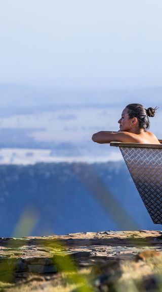 Woman enjoying Bubbletent Australia's outdoor bathtub with scenic views, Capertee Valley