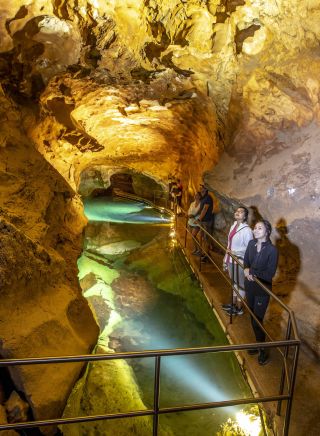 Small group enjoying a tour through the River Cave system at Jenolan Caves in the Blue Mountains