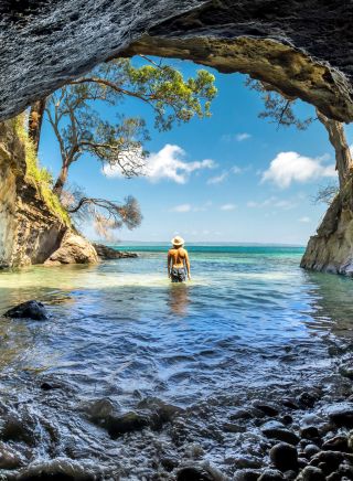 Man enjoying the sun from a sea cave in Jervis Bay, South Coast